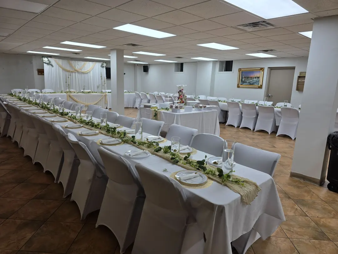 The community hall set with long tables for the Eid dinner