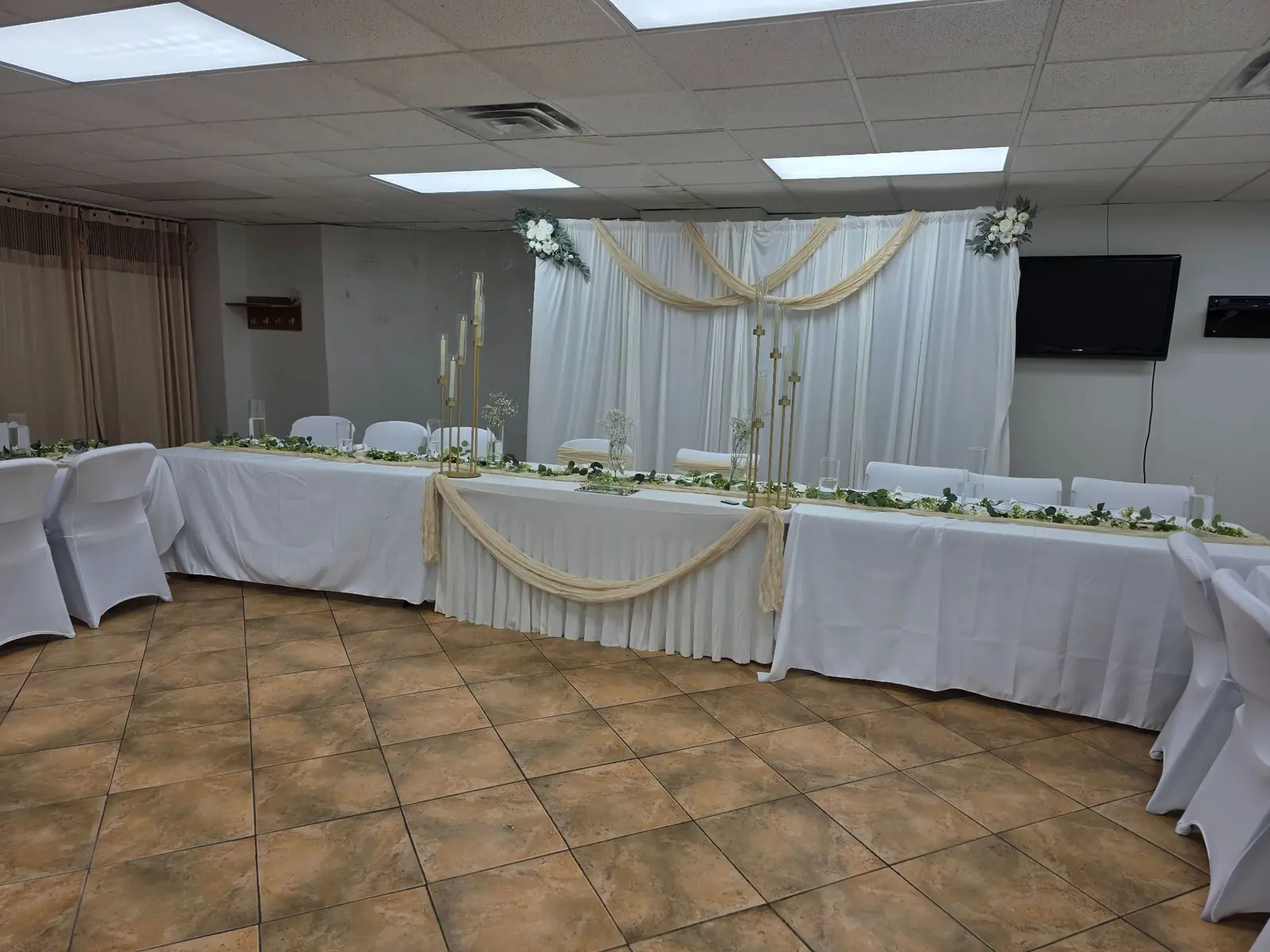 The head table and decorated backdrop in the community hall
